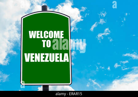 Green road sign with greeting message WELCOME TO VENEZUELA isolated over clear blue sky background Stock Photo