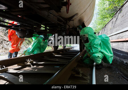 A team working with toxic acids and chemicals is securing a chemical cargo train tanks crashed near Sofia, Bulgaria. Teams from  Stock Photo