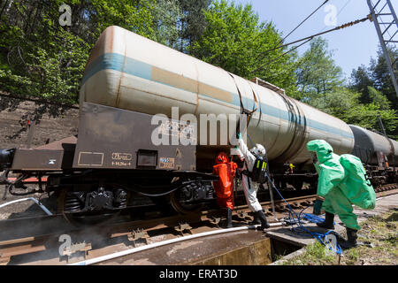 A team working with toxic acids and chemicals is securing a chemical cargo train tanks crashed near Sofia, Bulgaria. Teams from  Stock Photo