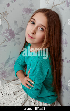 beautiful little girl with long hair on a floral background Stock Photo