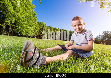 happy little boy laying on the grass Stock Photo