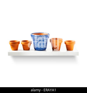 Clay flower pots in a row on shelf isolated on white background. Garden equipment. Group of objects with clipping path Stock Photo