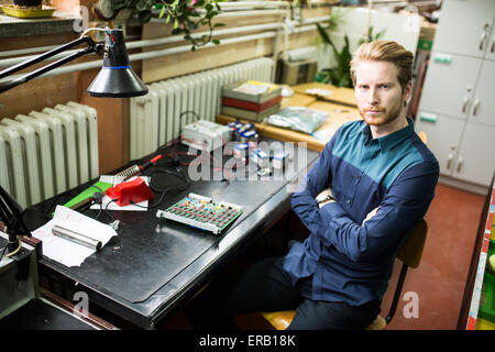 Young man in electronics workshop Stock Photo