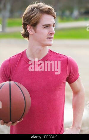 young man standing with basketball in his hands Stock Photo