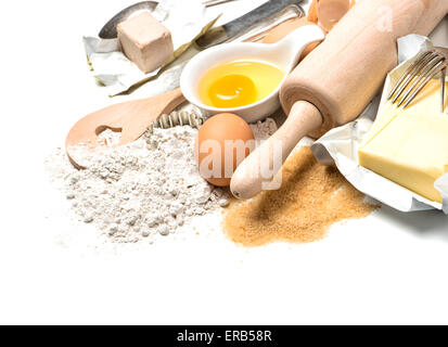 Baking ingredients eggs, flour, sugar, butter, yeast and rolling pin. Food background Stock Photo