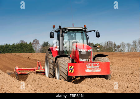 Making ridges for potato crop using a ridger pulled by a Massey Ferguson 7624, Yorkshire, UK Stock Photo