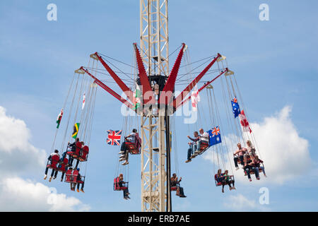 People enjoying a ride on the Starflyer Skyflyer aerial fairground ride at Bournemouth in May Stock Photo