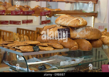 Inside a typical french boulangerie with various types of fresh loaves on display Stock Photo