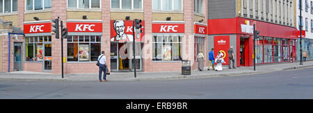 Kentucky Fried Chicken wide frontage on road junction corner site partly on East Ham high street and adjoining a Wilko store Newham East London UK Stock Photo