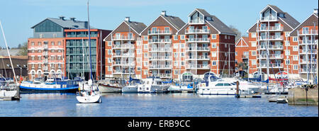 Panoramic view of modern apartments buildings with balconies overlooking boats and yachts on Ipswich Marina business Suffolk East Anglia England UK Stock Photo