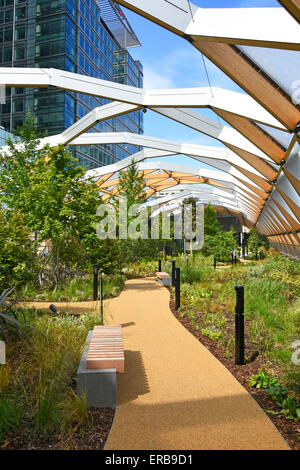Plants grow in Crossrail Place roof garden above Crossrail train station ETFE roof panels & glulam spruce timber beams Canary Wharf East London UK Stock Photo