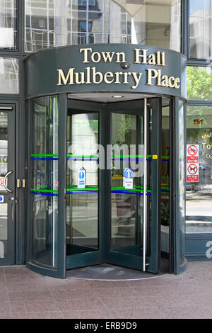 Sign above revolving door entrance to Tower Hamlets Town Hall Mulberry Place council offices building in East London England UK Stock Photo