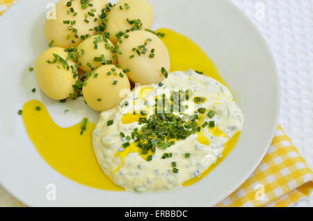 close up of a plate with curd cheese, boiled potatoes, linseed oil and chive, macro, detail, full frame,  horizontal Stock Photo