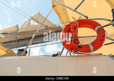 Lifebelt on the deck of a little ship. Stock Photo