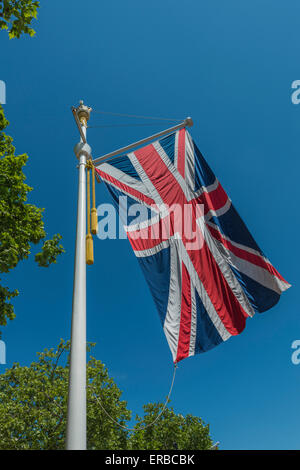 A large union flag flying from an ornate flagpole in the summer breeze Stock Photo
