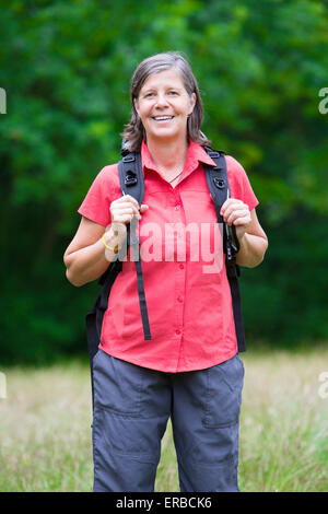 older woman is hiking in nature Stock Photo