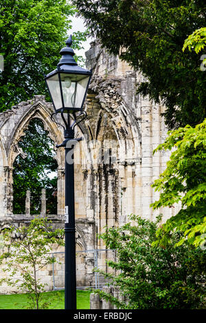 Remains of St Mary's Abbey church. Archway and window with lamppost in the Museum Gardens, City of York, England, UK. Vertical Stock Photo