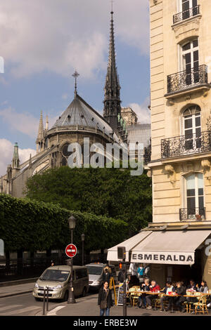 A view of Esmerelda French cafe and the east facade of the medieval gothic Notre Dame cathedral, Paris, as seen from Pont Saint Louis. France Stock Photo