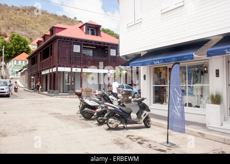 Shops and scooters along Rue de la Republique, in Gustavia, St. Barts Stock Photo