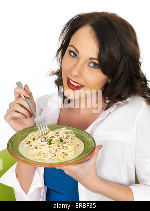 Happy Smiling Beautiful Young Woman in Her Twenties Holding a Plate of Spaghetti Carbonara Pasta Stock Photo