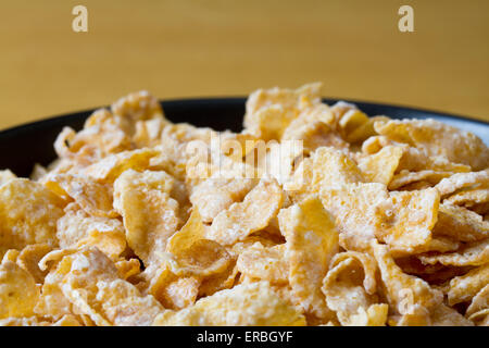 Black bowl with frosted cereal flakes Stock Photo