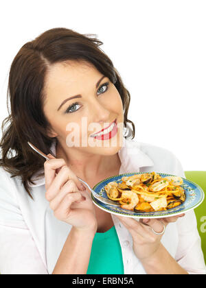 Confident Happy Young Woman Eating Italian Style Seafood Linguine Pasta Meal Isolated Against A White Background With A Clipping Path And Copy Space Stock Photo