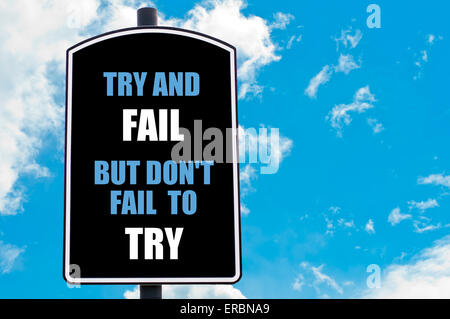 TRY AND FAIL BUT DO NOT FAIL TO TRY written on road sign isolated over clear blue sky background with available copy space Stock Photo