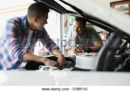 Father And Son Restoring Vintage Car Engine Garage Stock Photo