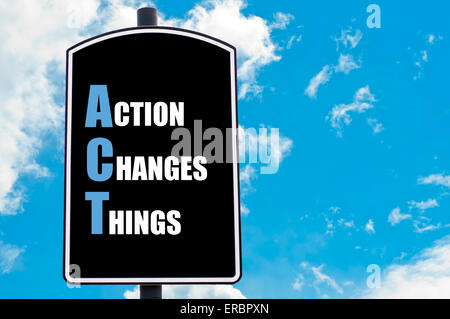 ACT as ACTION CHANGES THINGS  motivational quote written on road sign isolated over clear blue sky background Stock Photo