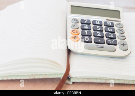 Calculator on blank notebook, stock photo Stock Photo