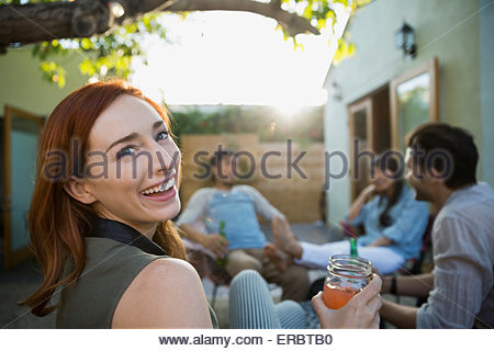 https://l450v.alamy.com/450v/erbtb0/portrait-smiling-friend-drinking-with-friends-on-patio-erbtb0.jpg