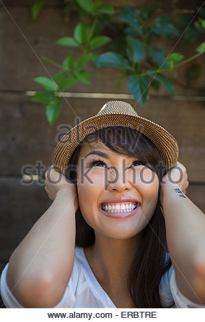 Portrait enthusiastic woman with black hair wearing hat