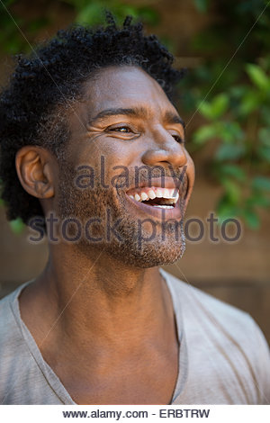 Close up portrait laughing man stubble curly hair