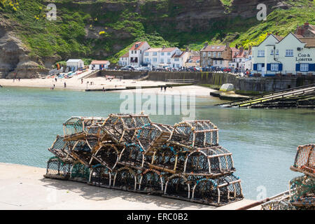 Lobster or crab pots stacked on the quayside at Staithes, North Yorkshire, UK ready for use. Stock Photo