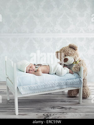 Little sleeping toddler and the teddy bear Stock Photo