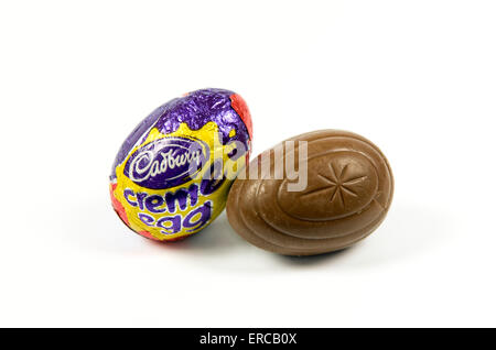 Cadbury creme eggs on white background with open cut up bar by the side Stock Photo