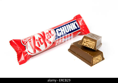 Chunky kitkat bar on white background with open cut up bar by the side Stock Photo