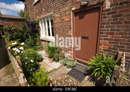 UK, England, Cheshire, Styal, Farm Fold small front garden with wooden picket fence of rented cottage Stock Photo