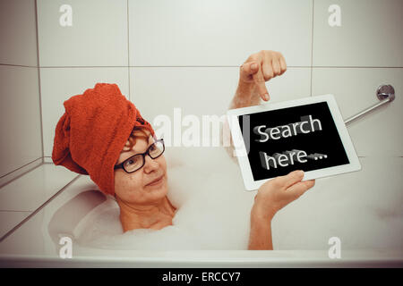 Woman in bathtub with tablet computers, space for text, retro style Stock Photo