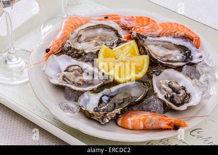 oysters shell, jumbo shrimp with lemon on ice, top view Stock Photo