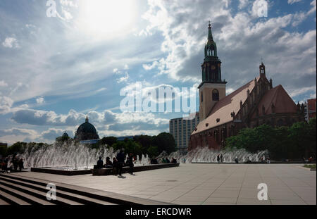Fountains in sunlight in front of St Marys Church with the Berlin Dome in the background Stock Photo