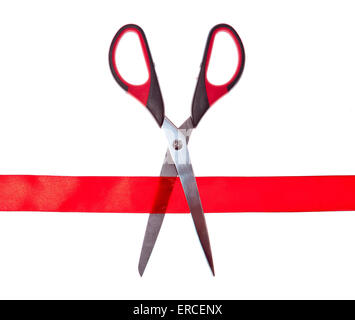 Scissors cutting through red ribbon or tape, isolated on white Stock Photo
