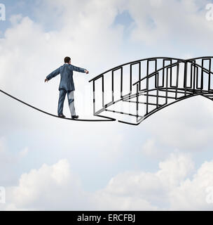 Risk reduction concept as a businessman on a tightrope walking on a wire that becomes shaped as a safe three dimensional bridge Stock Photo
