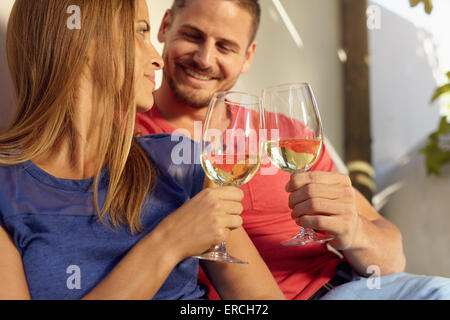 https://l450v.alamy.com/450v/erch72/closeup-shot-of-young-man-and-woman-sitting-together-toasting-wine-erch72.jpg