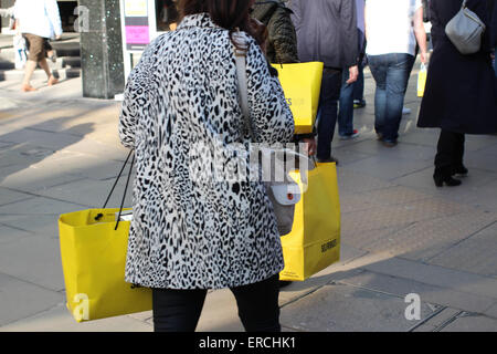 Female shopper on Oxford Street carrying Selfridges shopping bags Stock Photo