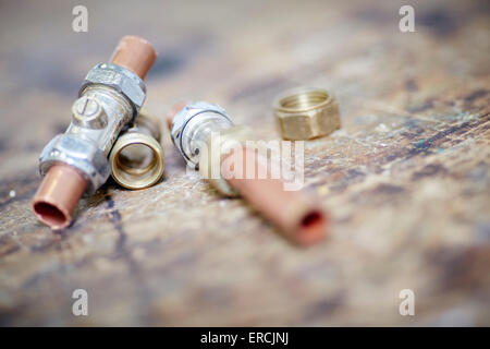 plumber plumbing copper pipes and fittings workshop Stock Photo