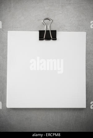 note paper and clip at metal background texture Stock Photo