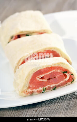 Salmon lavash rolls with cheese and dill on white plate Stock Photo