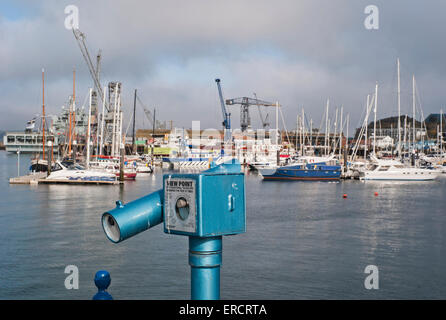 A public coin-operated telescope overlooking the the Packet Quay in  falmouth harbour Cornwall Stock Photo