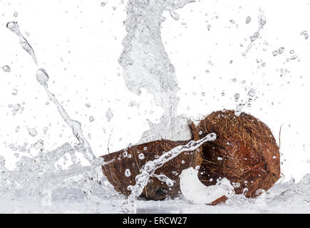Cracked coconuts on white background, close-up. Stock Photo